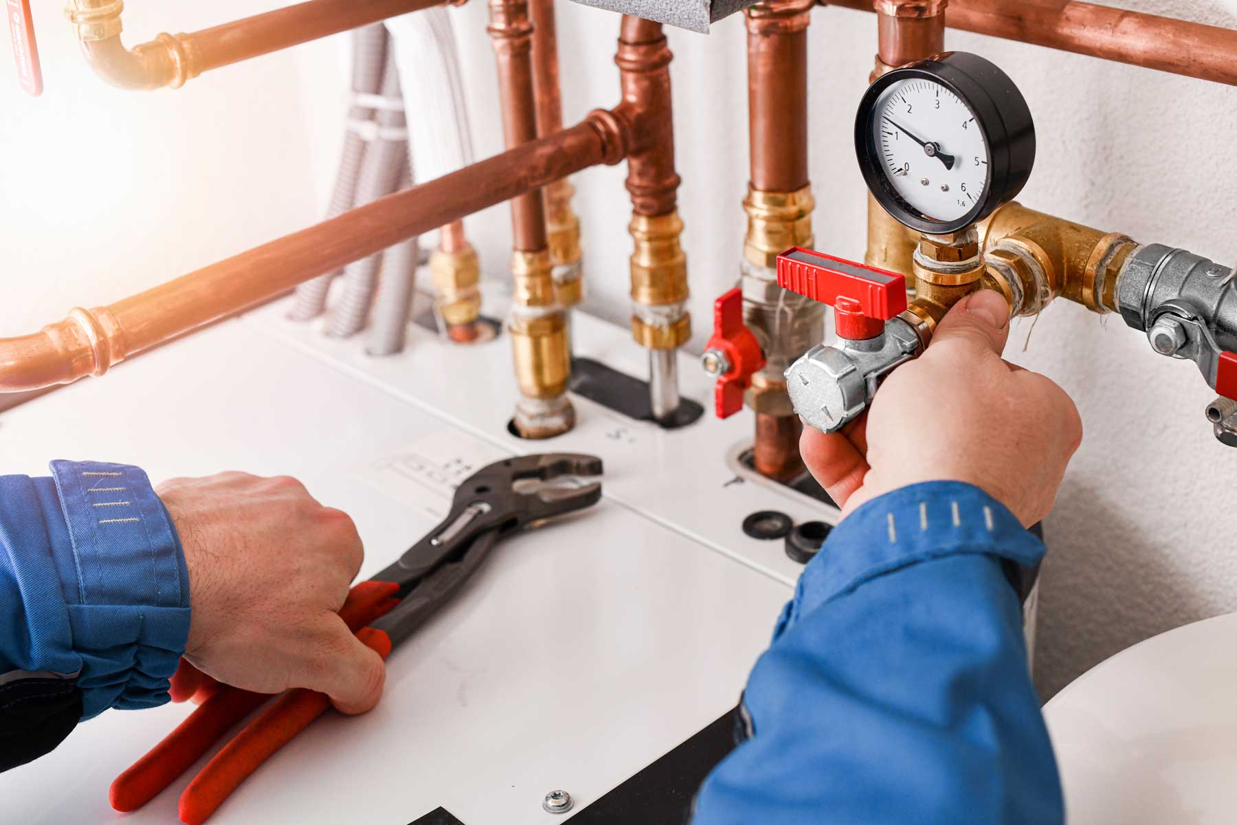 Plumbing concept or service worker. Copper pipelines close up wi